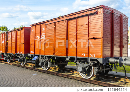 Red orange vintage retro train steam locomotive wooden wagon Belarus. 125644254