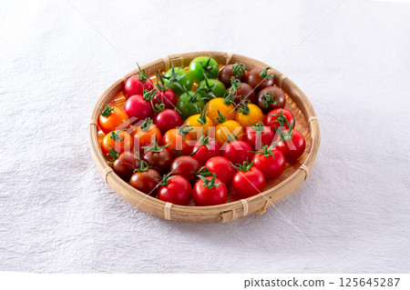 Colorful cherry tomatoes in a basket Colorful cherry tomatoes in a basket 125645287