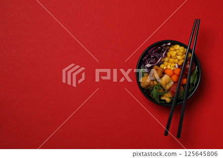 Fried tofu salad on a red background Fried tofu salad on a red background 125645806