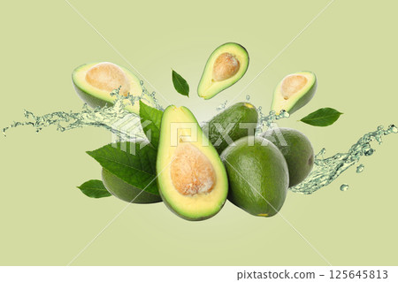 Healthy food, Avocados, leaves and water on light green background Healthy food, Avocados, leaves and water on light green background 125645813