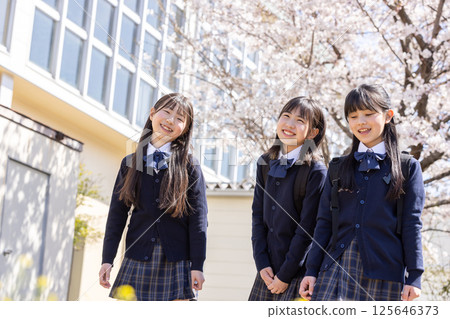 Spring school building and smiling students 125646373