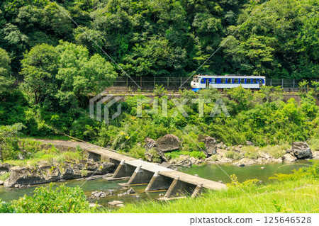 The Shikoku Shinkansen on the Yodo Line runs alongside the Shimanto River submerged bridge 125646528