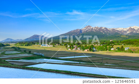 Echigo Tokimeki Railway running with Mt. Myoko in the background Echigo Tokimeki Railway running with Mt. Myoko in the background 125646591