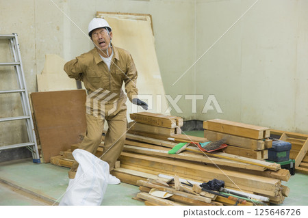 Worker at demolition site suffering from back pain 125646726