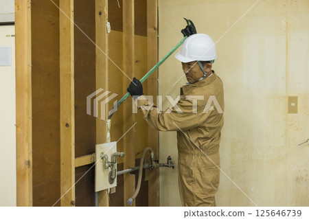 Workers working at a demolition site Workers working at a demolition site 125646739