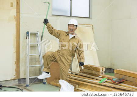 Workers working at a demolition site 125646783