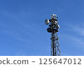 Communication tower and antenna equipment stretching into the blue sky 125647012