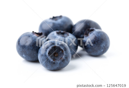 Group of raw blueberries isolated on white surface in natural light, promoting fresh vegan organic ingredients for food design or healthy products 125647019