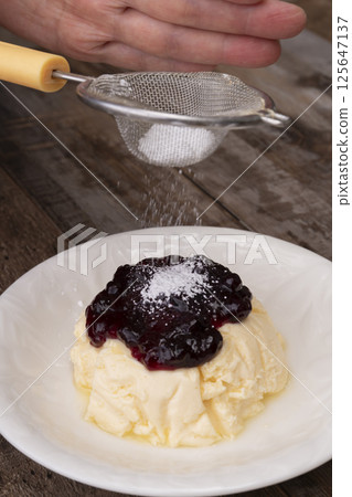 A cake made with high-protein Greek yogurt and finished with blueberry sauce 125647137