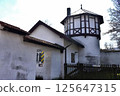 White-walled building with an octagonal tower and timber-framed design (Germany) 125647315