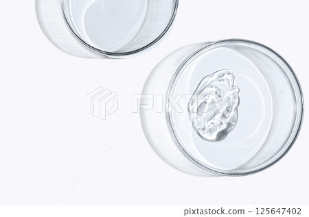Skin serum or face wash gel in a Petri dish. For cosmetic procedures. White background 125647402