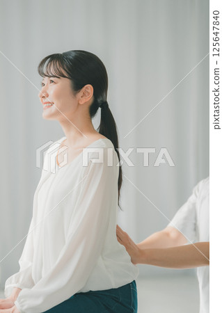 Lower back palpation 125647840