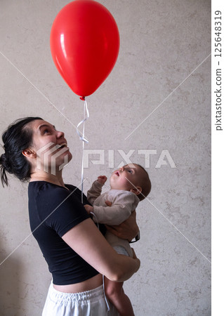 Mother and Baby with Red Balloon 125648319