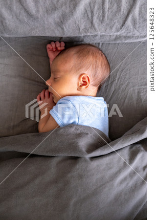 Peaceful Sleeping Baby on Gray Blanket 125648323