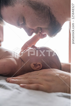 Father and Newborn Sharing a Tender Moment Father and Newborn Sharing a Tender Moment 125648327