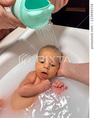 Newborn Baby Bathtime in little bath 125648358
