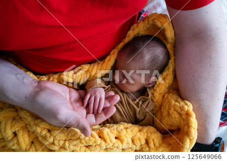 Newborn Baby Holding Adult's Hand 125649066