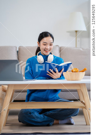 Office worker lifestyle people. Woman writing notes on book and using laptop. home office workplace lifestyle people. 125649295