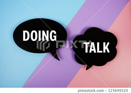 Doing vs Talk text on speech bubble top view on blue, purple and pink geometric background Doing vs Talk text on speech bubble top view on blue, purple and pink geometric background 125649320
