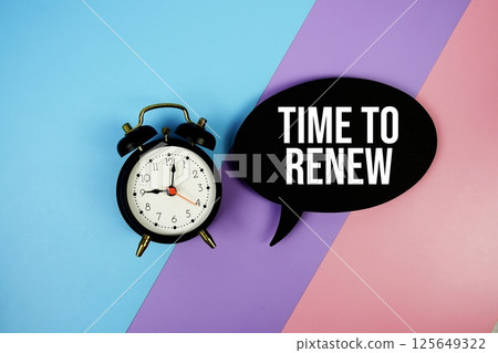 Time To Renew text motivational and inspiration quote with alarm clock on blue, purple and pink geometric background Time To Renew text motivational and inspiration quote with alarm clock on blue, purple and pink geometric background 125649322