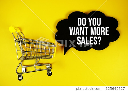 Do you want more sales? text on speech bubble with mini trolley shopping cart top view on yellow background 125649327