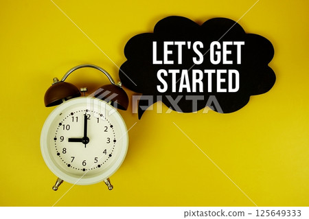 Let's Get Started text on speech bubble top view on yellow background 125649333