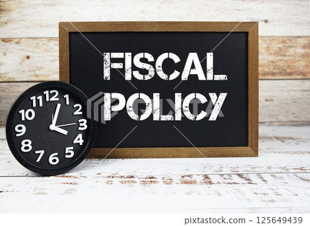 Fiscal Policy text message and alarm clock on wooden background Fiscal Policy text message and alarm clock on wooden background 125649439
