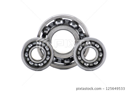 Three metallic ball bearings forming a triangular shape isolated on white background Three metallic ball bearings forming a triangular shape isolated on white background 125649533