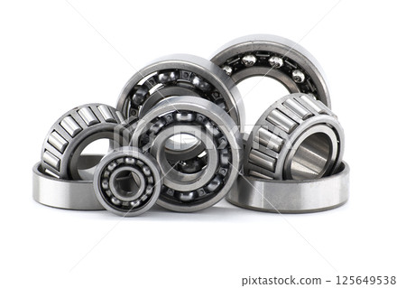 Assortment of various bearings isolated on a clean white backdrop, close up details. 125649538