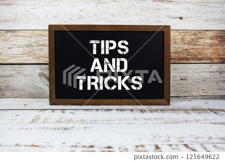 Tips and Tricks typography text on wooden blackboard Tips and Tricks typography text on wooden blackboard 125649622