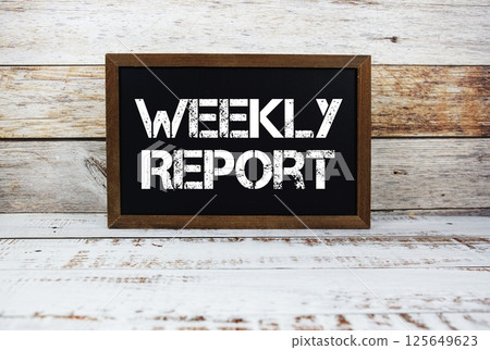 Weekly Report typography text on wooden blackboard Weekly Report typography text on wooden blackboard 125649623