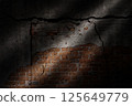 Brick wall crack with shadows surrounding it with sunlight hitting, great for your design and texture background 125649779