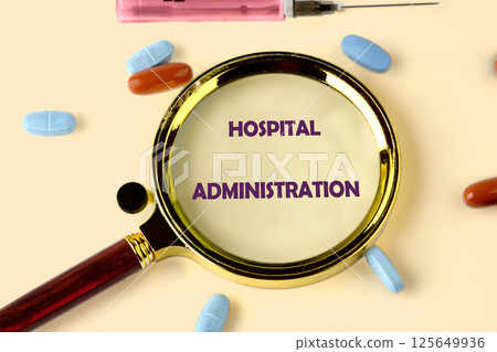 A magnifying glass highlights hospital administration, surrounded by pills and a syringe, showcasing the vital role of healthcare management today A magnifying glass highlights hospital administration, surrounded by pills and a syringe, showcasing the vital role of healthcare management today 125649936