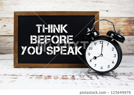 Think Before You Speak text message and alarm clock on wooden background Think Before You Speak text message and alarm clock on wooden background 125649976