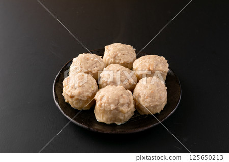 Chicken shumai on a black background Chicken shumai on a black background 125650213