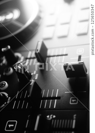 Deejay mixing desk 125650347