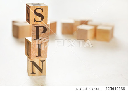 Four wooden cubes arranged in stack with word SPIN (meaning Solution Problem Implication Need) on them, space for text / image at down right corner Four wooden cubes arranged in stack with word SPIN (meaning Solution Problem Implication Need) on them, space for text / image at down right corner 125650388