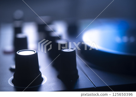Dj turntables in nightclub 125650396