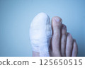 Foot big toe bandage injury 125650515