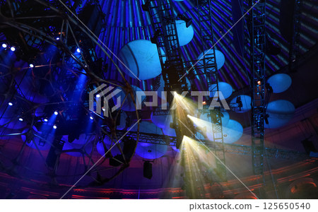 Reflector lights shining through smoke on theatre roof before performance Reflector lights shining through smoke on theatre roof before performance 125650540