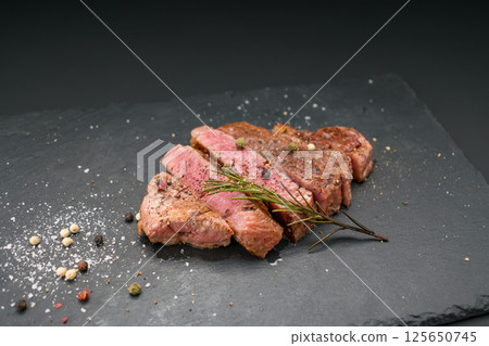 Japanese Black Beef Fillet Steak, Grilled and Cut on a Plate Japanese Black Beef Fillet Steak, Grilled and Cut on a Plate 125650745