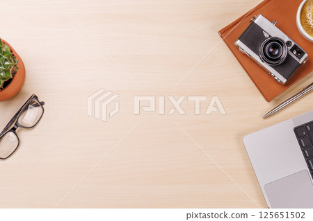 A clean and minimal desk setup featuring a laptop and a coffee cup A clean and minimal desk setup featuring a laptop and a coffee cup 125651502