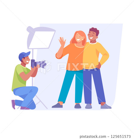 A couple joyfully posing for a professional photographer in a creatively lit studio A couple joyfully posing for a professional photographer in a creatively lit studio 125651573