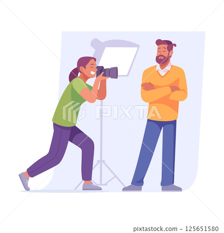 A skilled photographer is focused on capturing their subject beautifully in a studio setting 125651580