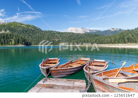 Scenic lake view with small boats gently floating 125651647