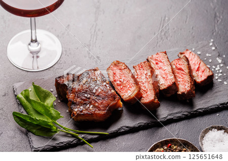 A perfectly cooked sliced striploin steak with a juicy, tender texture 125651648
