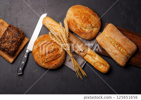 An assortment of freshly baked bread displayed on a table 125651656