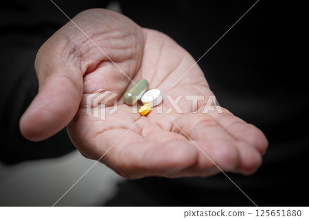 Hand Holding Daily Medications 125651880