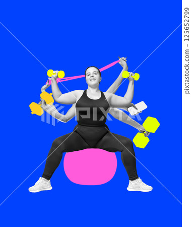Confident woman sitting on fitness ball with multiple hands holding colorful dumbbells phone and resistance band against blue background 125652799