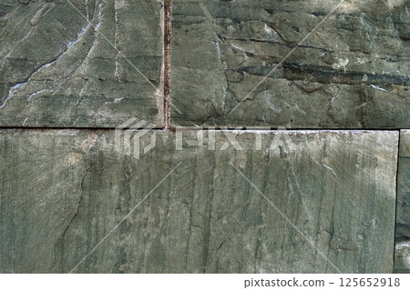 Green marble wall of rough colored blocks. Abstract background. Green marble wall of rough colored blocks. Abstract background. 125652918
